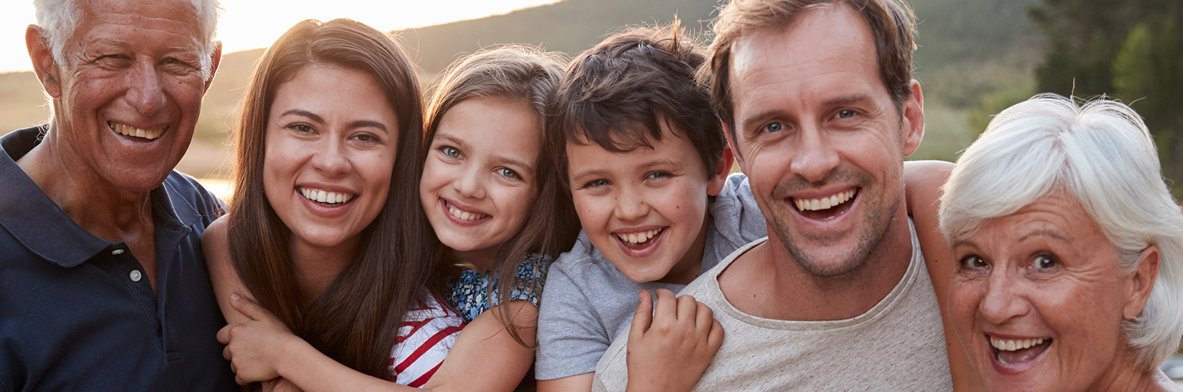 "Large family smiling together"