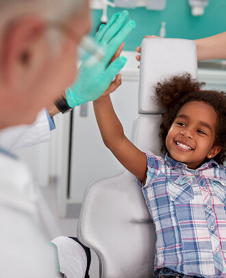 little girl high fiving dentist