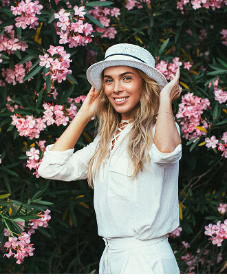 woman posing in front of flowers