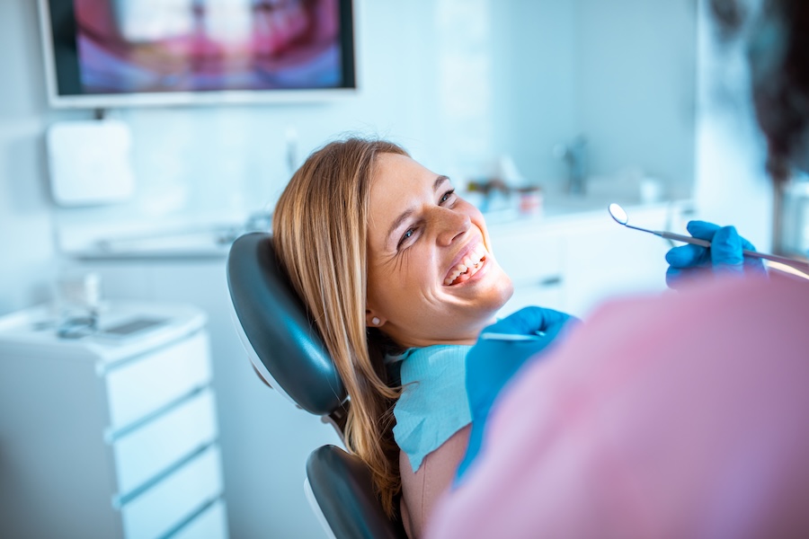 woman in dental chair for invisalign consultation